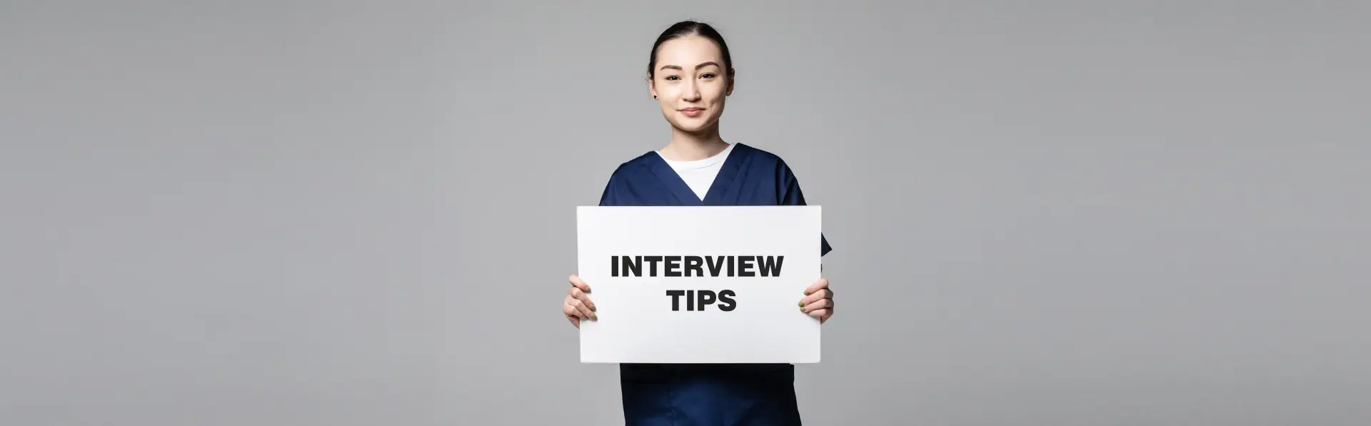 Interview Tips — professional nanny holding interview tips sign